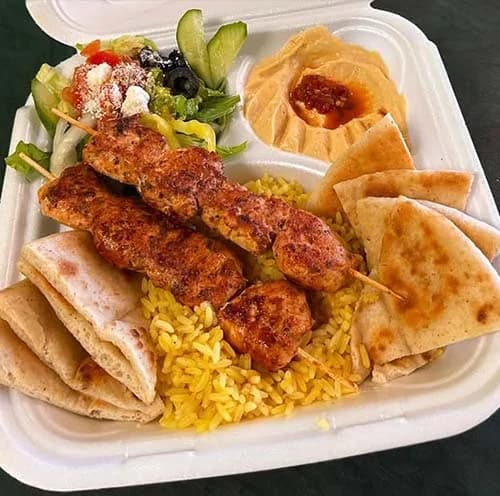 Chicken kabob platter with rice, salad, pita and hummus
